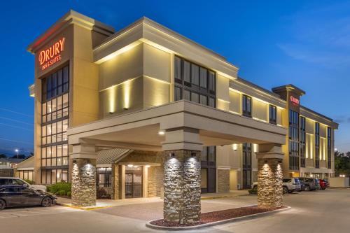 a hotel building with a car parked in a parking lot at Drury Inn & Suites Springfield MO in Springfield