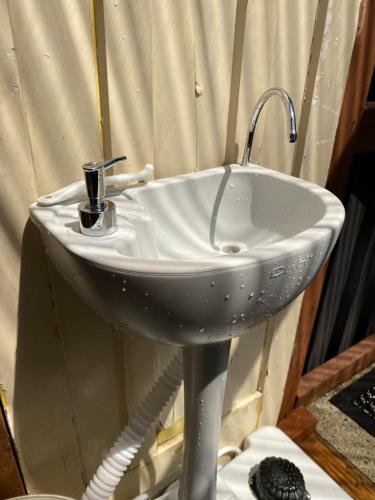 a white sink with a cup on top of it at Evermore Stay in Richmond