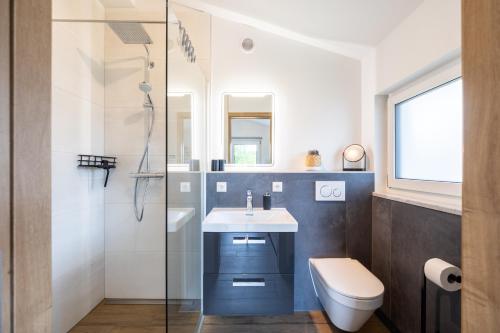a bathroom with a sink and a toilet and a shower at Ferienwohnung Morgensonne in Bad Feilnbach