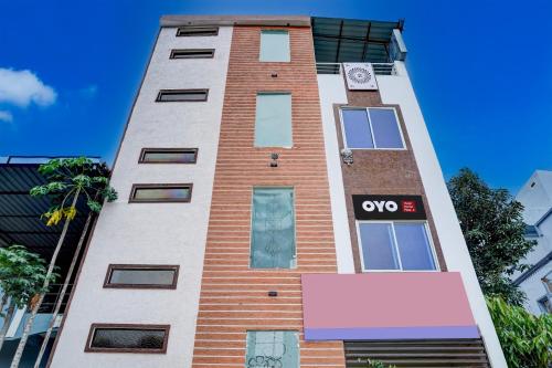 a tall brick building with a sign on it at Hotel O Shivay Inn Ayodhaya Bypass Road in Bhopal