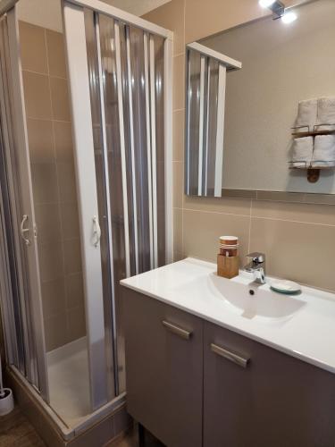 a bathroom with a sink and a shower at Amadour Hôtel in Rocamadour