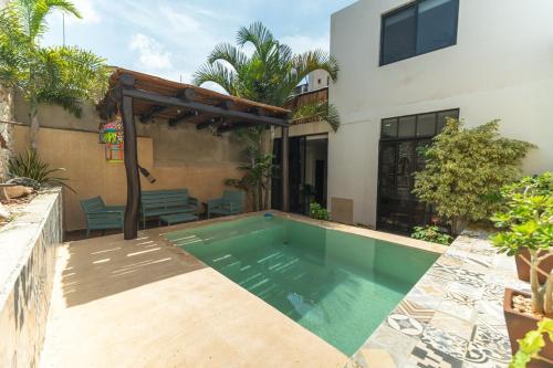 a swimming pool in the backyard of a house at Casa Mariano Merida by WoWay Experiences in Mérida