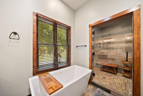 a bathroom with a large tub and a shower at Cranberry View Lodge in Newland