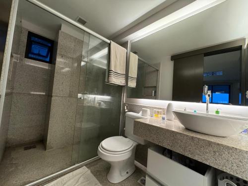 a bathroom with a toilet and a sink and a shower at Flats no Hotel Mercure Belém Boulevard in Belém