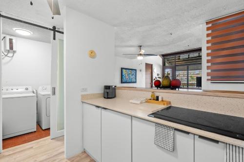 a kitchen with white cabinets and a counter top at Balcony Pet-friendly Parking Leisure in Beltran