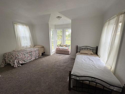 a bedroom with two beds and a window at 2 Story Home in the Noto Arts District in Topeka