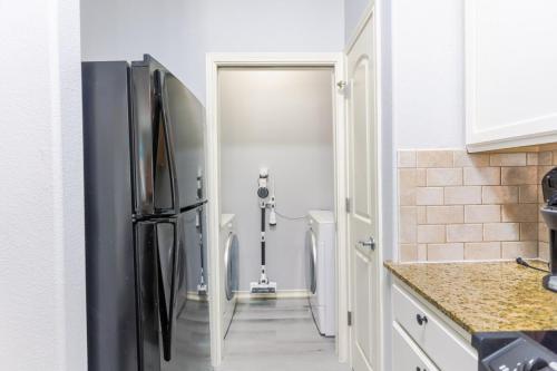 a kitchen with a black refrigerator in a kitchen at Entire House - Spacious 3 Bedroom on the Island in Corpus Christi