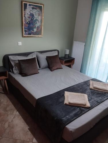 a bed with two towels on it in a bedroom at Gianis Homme in Alexandroupoli