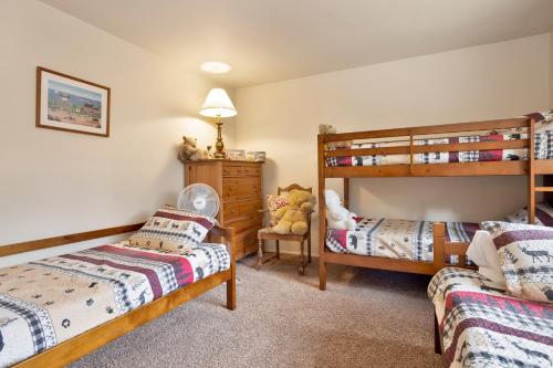 a bedroom with two beds and a bunk bed at Idle hours inn #1945 in Big Bear City