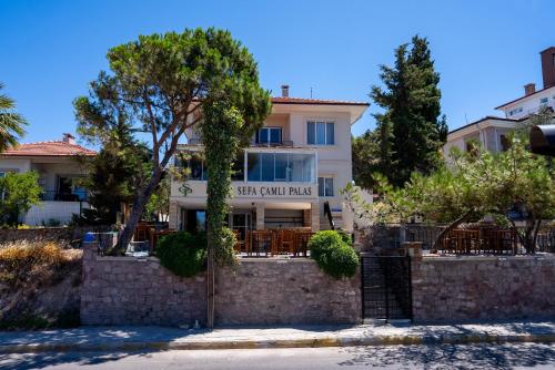 a building with a sign that reads stay our rules at Sefa Çamlı Palas in Ayvalık