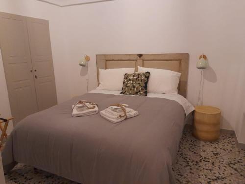 a bedroom with a bed with two towels on it at Suite Alborelli in Alberobello