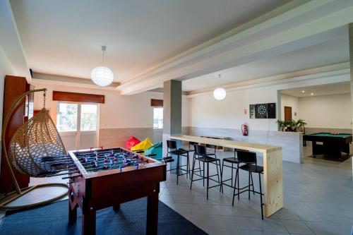 a living room with a foos ball on a table at Refúgio Do Artista Country House Viana Do Castelo in Mazarefes