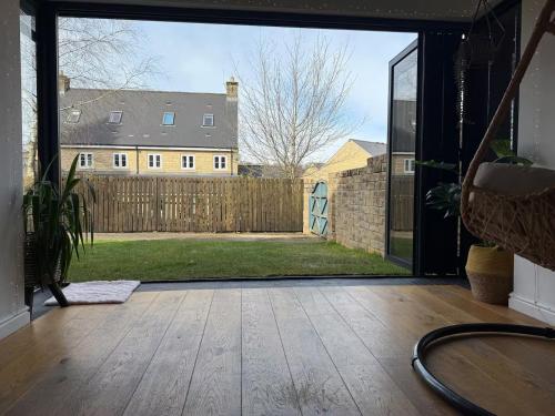 an open patio door with a view of a yard at West Lodge - Buxton in Buxton