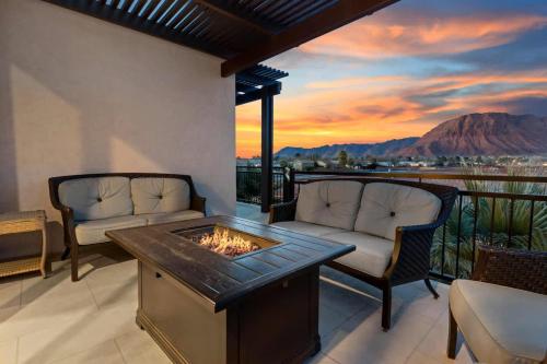 a living room with a fireplace on a balcony at 31| Pool Palace in St George with Snow Canyon View in Santa Clara