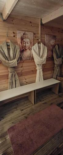 a shelf in a room with curtains on a wall at Les Mini-Chaumières in Saint-Martin-Saint-Firmin