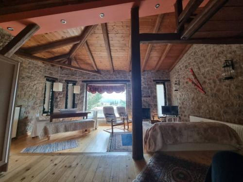 a living room with a couch and a table at Stone View Nest - By Ski Alure in Arachova