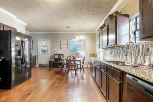 a large kitchen with a table and chairs in it at 126 Lucas Street in San Antonio