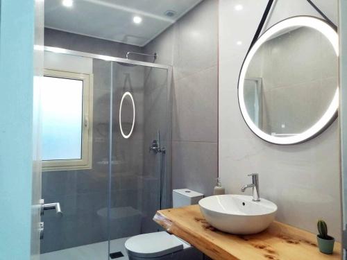 a bathroom with a sink and a shower and a mirror at Casa Do Cabo Ponte De Lima - Jacuzzi And Pool in Ponte de Lima