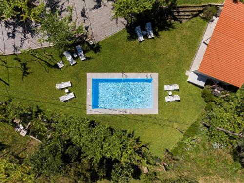 an overhead view of a swimming pool on a lawn at Casa do Cabo Ponte de Lima - Jacuzzi and Pool in Ponte de Lima