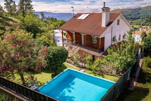 an aerial view of a house with a swimming pool at Casa Das Fontes Ponte de Lima - Jaccuzzi and Pool in Ponte de Lima