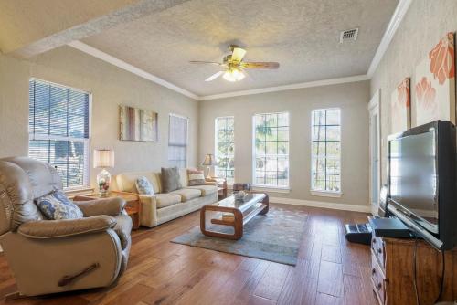 a living room with a couch and a flat screen tv at 126 Lucas Street in San Antonio