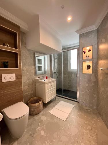 a bathroom with a toilet and a sink and a shower at Torri Studios in Sliema