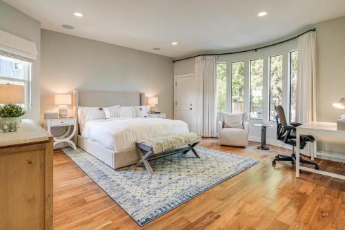 a bedroom with a bed and a desk and a table at Walk to Ocean Luxe Family Home in Half Moon Bay! in Half Moon Bay