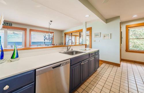 a kitchen with a sink and a counter at Family Tradition - Duck, Sanderling, Soundfront, Private Pier, Sunset Views, Community Pool, Pets OK in Duck