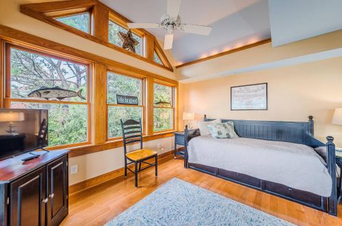 a bedroom with a bed and a flat screen tv at Family Tradition - Duck, Sanderling, Soundfront, Private Pier, Sunset Views, Community Pool, Pets OK in Duck