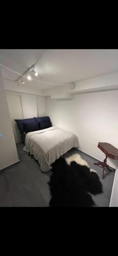 a bedroom with a bed and a table in it at Apartment for rent in Oslo