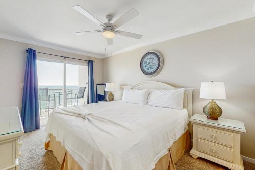 a bedroom with a bed and a clock on the wall at Ocean House II 2602 in Gulf Shores