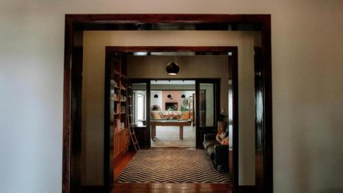 a hallway with a door open to a living room at 13 Olives, Entire Grape & Olive Estate, Somerset West by Euphoric Leisure in Sir Lowryʼs Pass