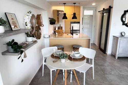 a kitchen and dining room with a white table and chairs at Oceanfront Oasis - Panoramic Views & Marina Access in Beltran