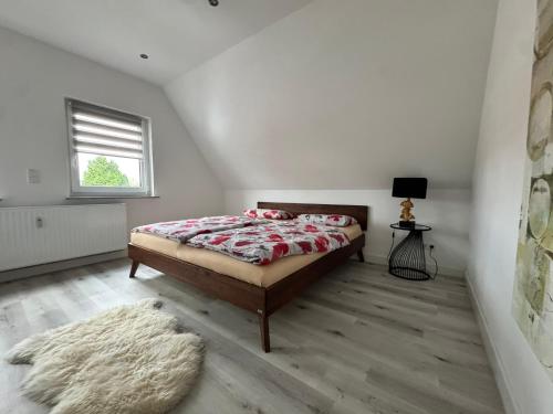 a bedroom with a bed and a rug at Gemütlich wohnen in Brake in Bielefeld