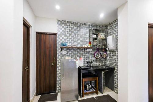 a kitchen with a refrigerator and a counter at Susegad by Palette Homes in Candolim