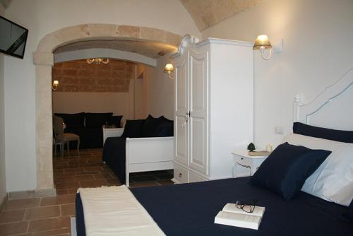 a bedroom with a bed and a living room at AFFITTACAMERE La Cattedrale in Monopoli