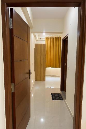 an empty hallway with a door and a room at Quality Comforts Guest House in Bangalore