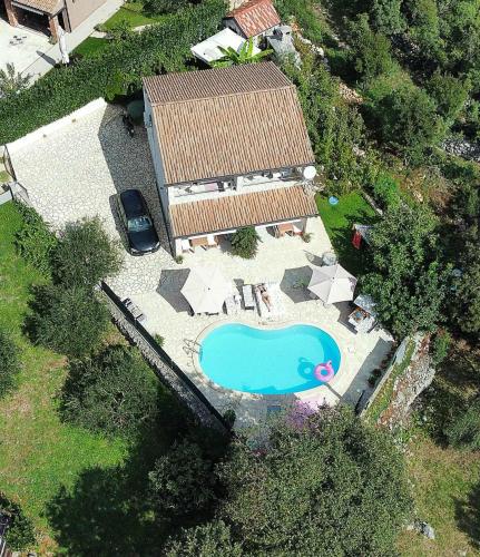 an aerial view of a house with a swimming pool at Villa Androcec in Žgaljić