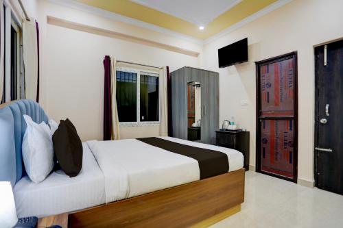 Un dormitorio con una cama y un televisor. en Hotel O kumar inn, en Lok Nayak Jayaprakash Airport