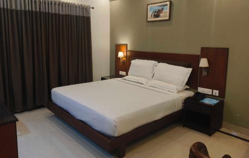 Ένα ή περισσότερα κρεβάτια σε δωμάτιο στο Hotel O Thumba Beach Trivandrum