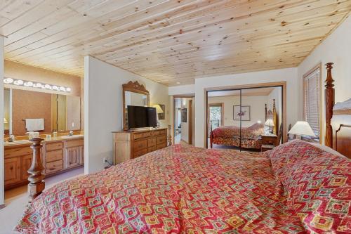 a bedroom with a bed and a television in it at Beaverhead 1421 in Big Sky