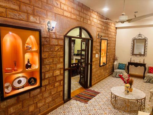 a living room with a brick wall at Sajjan Niwas - A Luxury Homestay in Jodhpur