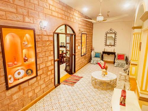 a living room with a brick wall at Sajjan Niwas - A Luxury Homestay in Jodhpur