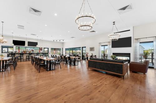 a dining room with tables and chairs and windows at Grand Crowne Resort in Branson