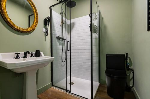 a bathroom with a sink and a glass shower at HN Salteras in Salteras