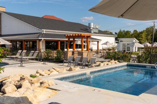 a swimming pool in front of a house at Grand Crowne Resort in Branson