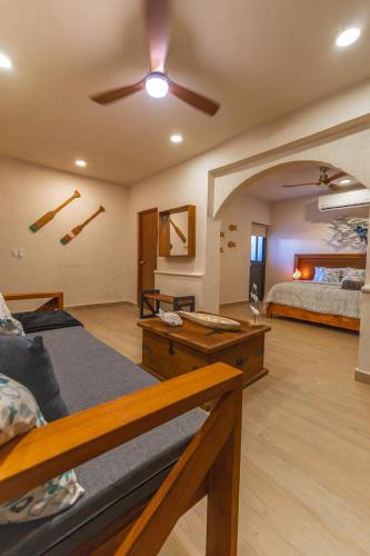 a room with two beds and a ceiling fan at Villas Manglar Sisal 3 by WoWay Experiences in Sisal