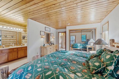 a bedroom with a bed and a bathroom at Downhill Beaverhead in Big Sky