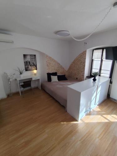 a bedroom with a bed and a desk and a table at Apartmán u Zámku Jindřichův Hradec pro 2-4 osoby in Jindrichuv Hradec