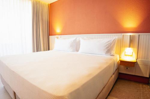 a bedroom with a large bed with white pillows at Zapadilly Tree Hotel in San Andrés
